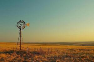 Windmill in a sun bleached field, stillness in the air after a day of relentless sun photo