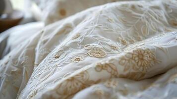 Close up of an elegant embroidered white duvet cover, perfect for wedding registry ideas and luxury home decor concepts photo