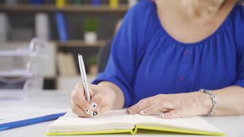 Businesswoman holding notepad and pen. video