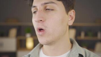 Young man with bad breath is disgusted. video