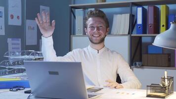 Happy businessman greeting the camera. video