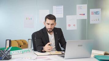 Young businessman works in his office. video