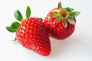 couple of vibrant red strawberries isolated on a white background photo