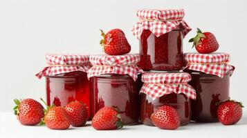 stack of homemade strawberry jam jars, gingham lids, isolated on a white background photo