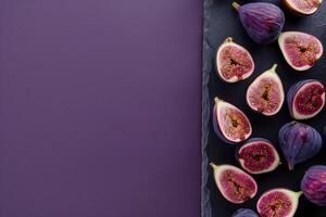 fresh figs on a dark slate isolated on a purple gradient background photo