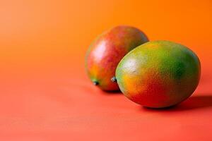 ripe mangoes on linen isolated on an orange gradient background photo