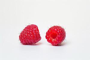 two ripe raspberries in sharp focus, contrasting against a white background photo