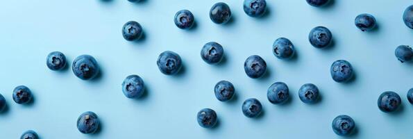 blueberries scattered across a pale blue surface, minimalist design with space for text photo