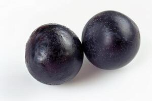 two acai berries, top view, vivid and distinct on a white background photo