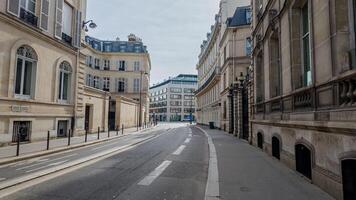 Deserted urban street in Paris with classical architecture, perfect for themes like city lockdown, early morning calm, or European travel photo