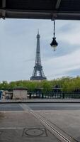 Springtime view of the Eiffel Tower from a Parisian street with budding trees, captured in Paris, France, on April 14th, 2024, ideal for travel and holiday themes photo