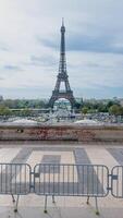 View of the iconic Eiffel Tower taken from a graffiti adorned vantage point, with barriers in the foreground, capturing the essence of Paris, France, on April 14th, 2024 photo