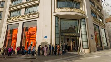 Shoppers waiting outside the Louis Vuitton store in Paris, France, highlighting luxury retail and consumerism, captured on April 14th, 2024 photo