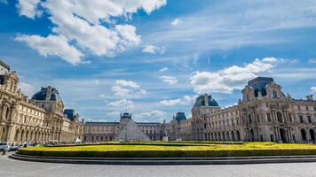 Sunny spring day view of the Louvre Museum with iconic glass pyramid, Paris, France, April 14th, 2024, ideal for travel and history themes photo