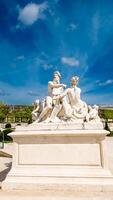 Classical white marble statue in Tuileries Garden, Paris, against a blue sky on April 14th, 2024, perfect for European history and art concepts photo