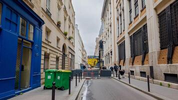 Urban renewal in Paris, France, showcasing construction machinery and pedestrians on a cloudy day, April 14th, 2024, reflecting infrastructure development and city life photo