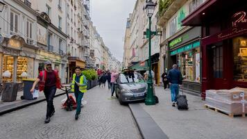 Diverse pedestrians and workers bustling on a lively Paris street, capturing everyday urban life under spring skies, France, April 14th, 2024 ideal for travel and culture themes photo