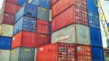 Jakarta, Indonesia on December 6, 2023. Stacks of colorful containers at a logistics warehouse in Cakung. photo