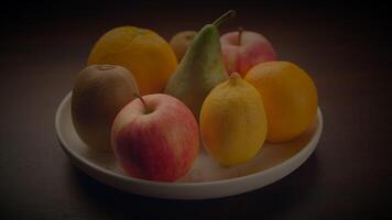 White plate with fruit, a natural and healthy staple food on the table video