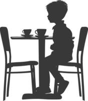 Silhouette little boy sitting at a table in the cafe black color only vector