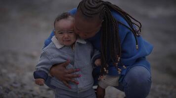 mãe segurando jovem bebê criança Garoto lado de fora desfrutando família vida video