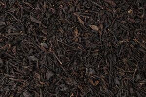 Dry tea leaves background or texture, black tea pattern photo