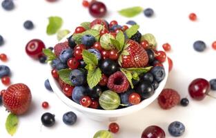 Mix of wild berries on white background photo