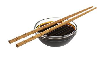 Soy sauce and chopsticks isolated on white background photo