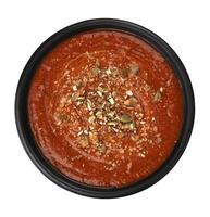 Bowl of tomato soup in black bowl, top view photo