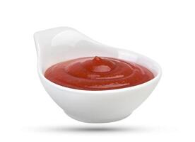 Bowl of tomato ketchup isolated on white photo