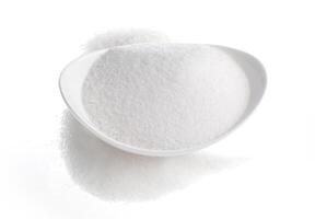 Bowl of sugar isolated on white background photo