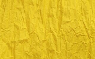 Yellow crumpled paper texture, grunge background photo