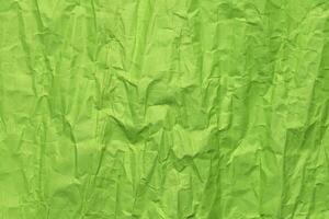 Green crumpled paper texture, grunge background photo