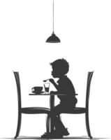 Silhouette little boy sitting at a table in the cafe black color only vector