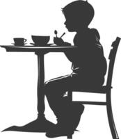 Silhouette little boy sitting at a table in the cafe black color only vector