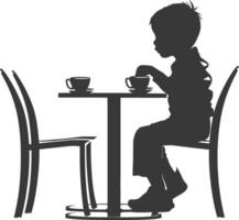 Silhouette little boy sitting at a table in the cafe black color only vector