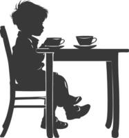 Silhouette little boy sitting at a table in the cafe black color only vector