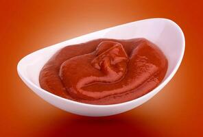 Ketchup in bowl isolated with clipping path photo