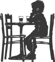 silueta pequeño chico sentado a un mesa en el café negro color solamente vector