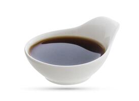 Dish of soy sauce isolated on white photo