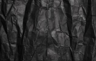 Black crumpled paper texture, grunge background photo