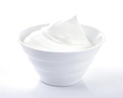 Bowl of cream on white background photo