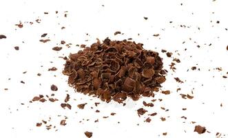 Grated chocolate. Pile of ground chocolate isolated on white background, closeup photo