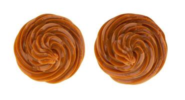 Swirl of caramel cream isolated on white background, top view photo