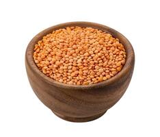 Orange lentils in wooden bowl isolated on white background photo