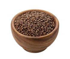 Brown lentils in wooden bowl isolated on white background photo