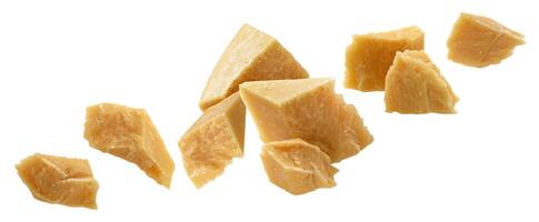 Falling broken pieces of parmesan cheese isolated on white background photo