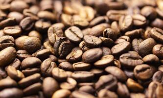 Pile of coffee beans texture, close up, dark background, shallow depth of field photo