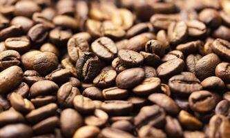 Pile of coffee beans texture, close up, dark background, shallow depth of field photo