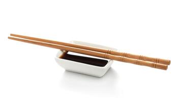 Soy sauce and chopsticks isolated on white background, with clipping path photo